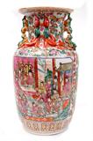 Lot 129: Chinese Qing Dynasty, Ch'ien Lung, Qianlong  Famille Rose
porcelain 14" vase having applied enamel panels depicting an Emperor and
 Court with geckos crawling up the neck with Foo Dog handles c.1736-1795
overall very nice condition, est. $600.00-$800.00