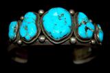 Lot 11: Stunning Navajo sterling turquoise 5 stone cuff set with
5 gem quality Kingman turquoise cabochons and inscribed with
Tribal registry numbers, retailed at $600.00 est. $100.00-$150.00