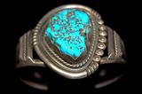Lot 9: Vintage Navajo old pawn sterling cuff set with a free-form Kingman
turquoise cabochon approx. 40 carats, artist signed "JT" est. $100.00-$190.00