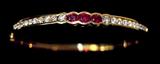 Lot 81: Lovely 18K diamond ruby hinged bangle bracelet set with 20 round
diamonds approx. 2.50 carats TDW and 3 oval rubies approx. 1 carat TCW
the diamonds VS1 clarity, G-H colour, the bangle weighing 14.2 grams, 
retail replacement value $8,950.00 est. $2,200.00-$3,200.00