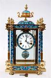 Lot 26: Lovely Chinese brass and cloisonné regulator clock
having a full cloisonné case and painted ship pendulum,
porcelain dial with beveled cut glass panels on all sides,
measuring 17" x 11" x 6", est. $250.00-$350.00