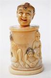 Lot 37: Japanese erotic ivory carved pedestal surmounted with
an articulated head and carved about the circumference with
anatomically correct amorous couples, having polychrome
scrimshaw, measuring 2.75" tall, artist signed
est. $250.00-$350.00