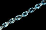 Lot 147: Lovely 10K blue topaz 16" necklace having 32 gemstones, each
separated with two 0.5 point diamond links approx. 0.31 carats TDW,
est. $1,200.00-$1,500.00