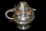 Lot 16: Fine hammered heavy silver-plate Georgian style teapot, having
a 1787 English GEORGIVS III shilling inset as a finial, the teapot measuring
6" x 7", hallmarked with a menorah, excellent condition,
 est. $150.00$200.00