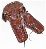 Lot 83: Alfonso's tooled leather Double Holster accented in nickel silver,
 for large frame .357 revolvers, the holsters measuring approx. 8" in length,
 belt measuring approx. 39", est. $450.00-$650.00