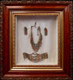 Lot 30: FINE custom shadowbox and Tibetian jewelry suite together
with a prayer wheel and adornment, the shadowbox measuring
21.5" x 19.5" (one lss to the upper right corner) and containing a
necklace, bracelet and earrings, the prayer wheel measuring 8.5"
and the adornment measuring 8.25", est. $200.00-$300.00
