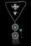 Lot 38: Group of 4 Vintage Zuni pieces to include a 19" necklace having 2
Sun God 2" medalions suspended from hand made links and sawtooth
bezel set with petit point Sleeping Beauty turquoise and coral cabochons,
each register surrounded with sterling twist wire and sterling concho
balls, together with a 2" x 2.25" Thunderbird dancer brooch, a 1.25" x 1"
Raincloud pin and a 2.5" stickpin, the necklace signed "Benji"
est. $150.00-$200.00