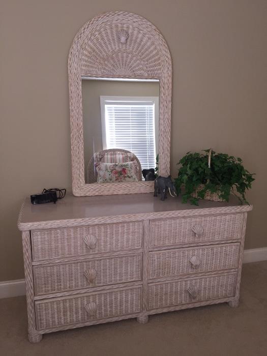 Pair of twin beds with wicker headboards, matching dresser with mirror