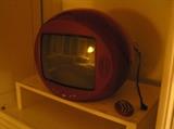 Vintage round face television with fold down helmet--works great!!! It's RED!!! And the remote is still with it!