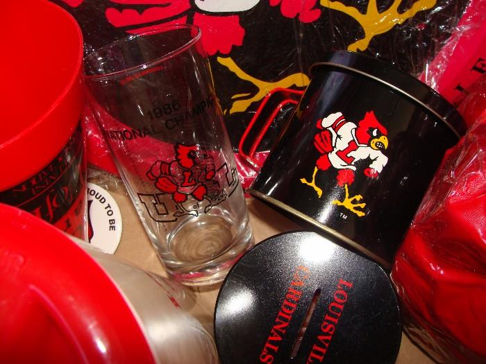 For the University of Louisville Fan! An entire box of "Fan"tastic items! 1986 Championship glass, pom poms, Lidded Tin Cups with Candles and slit for coin bank, Pillows, Blankets, Pitcher and more!!!