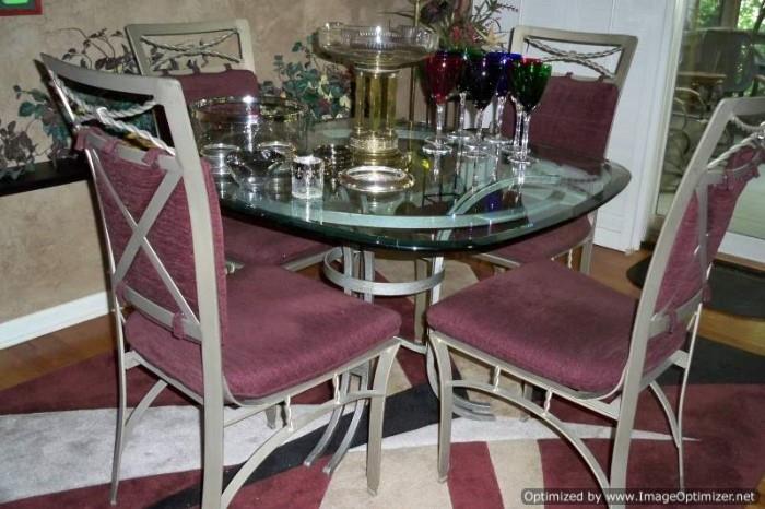 Glass and metal dining table with four chairs and miscellaneous glass
