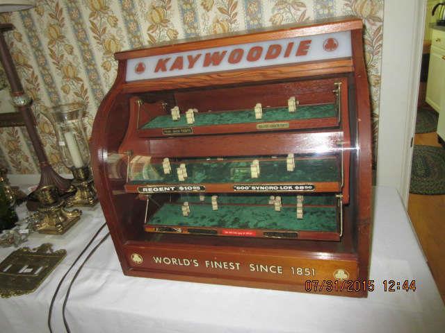 A large display case for Kaywoodie pipes and it rotates