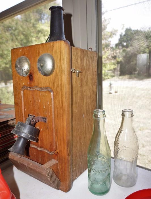 Dr Pepper bottles and antique phone