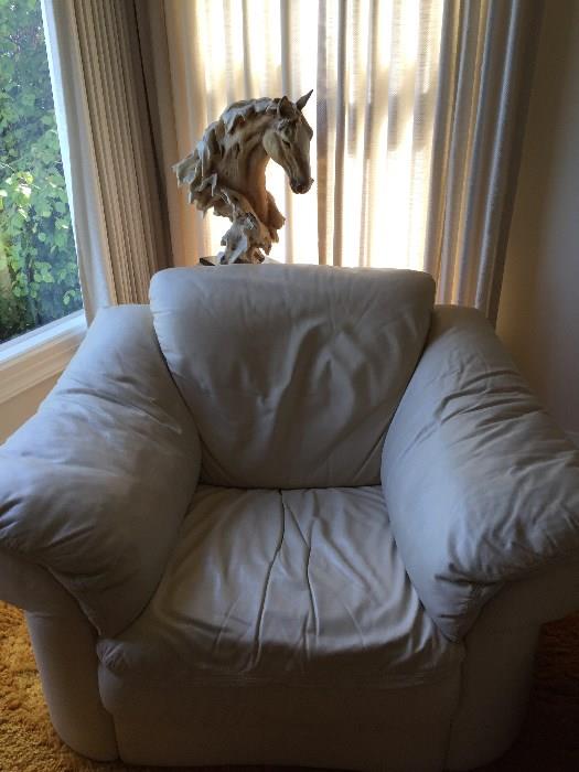 One of two cream leather chairs