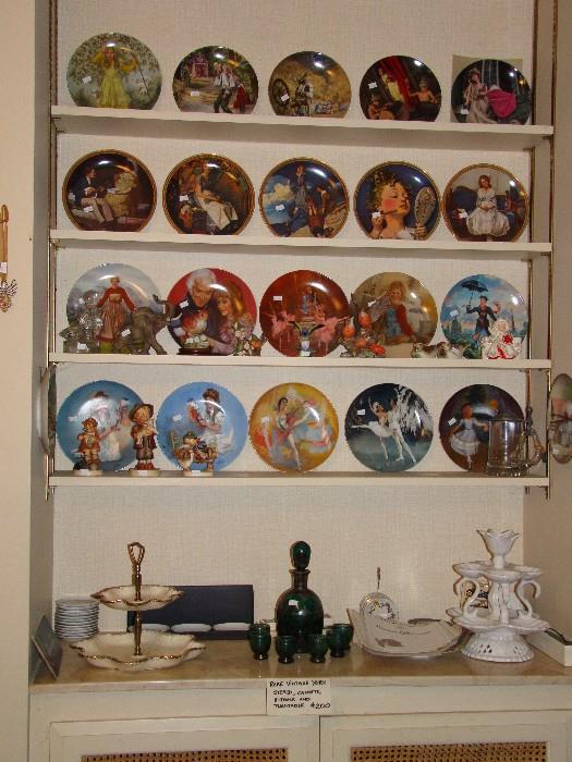 collector plates - mostly Disney, silver overlay decanter on bottom shelf in center