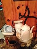 Set of enamelware on table full of small primitives