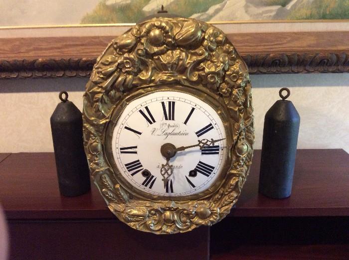 FRENCH MORBIER WALL CLOCK, , third quarter of the 19th century, having an ornate brass repousse dial frame and pendulum; complete with a pair of heavy cast iron weights
