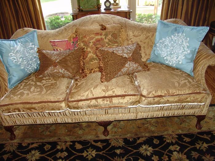 Upholstered Camel back sofa