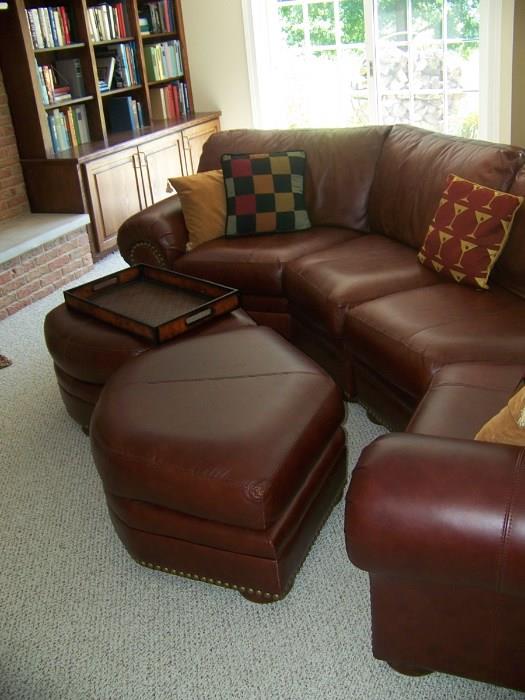 Leather sectional couch and two hassocks