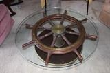 Ships wheel turned into glass coffee table.