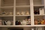 Collection of tea pots and sugar and creamers.