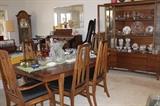 large dining table and eight chairs with two matching china hutches.