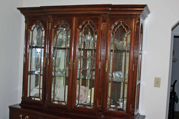 Cabinet is 47" high with four glass & wood doors. Also has two glass shelves and lighting.
