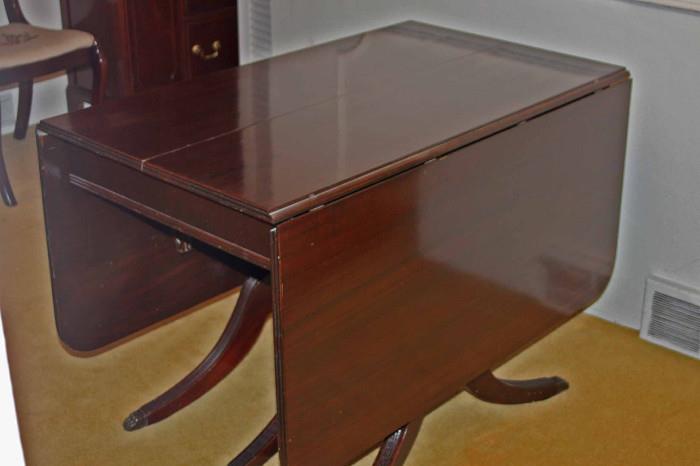 Strong hinges underneath the table allow each side to fold down for space saving storage if needed.