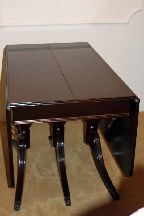 Strong hinges underneath the table allow each side to fold down for space saving storage, if needed.
