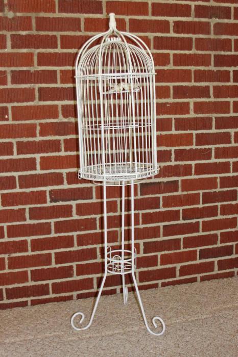 White wire birdcage with removable stand. Approximate dimensions is 46"H x 11.5"diameter.