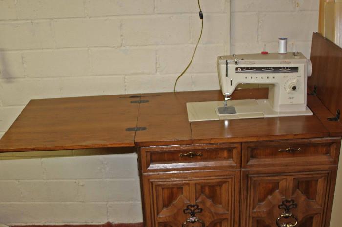 Singer sewing machine with console. When the top of the console is full extended it is 61"