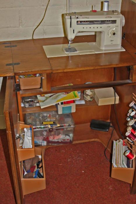 Singer sewing machine with console fully open. Lots of workspace and storage.