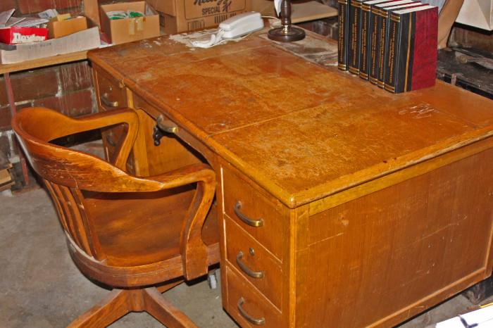 Solid oak desk with a typewriter hidden inside. Chair and desk are in good shape although worn from years of use. Refinishing would make a beautiful piece of furniture.