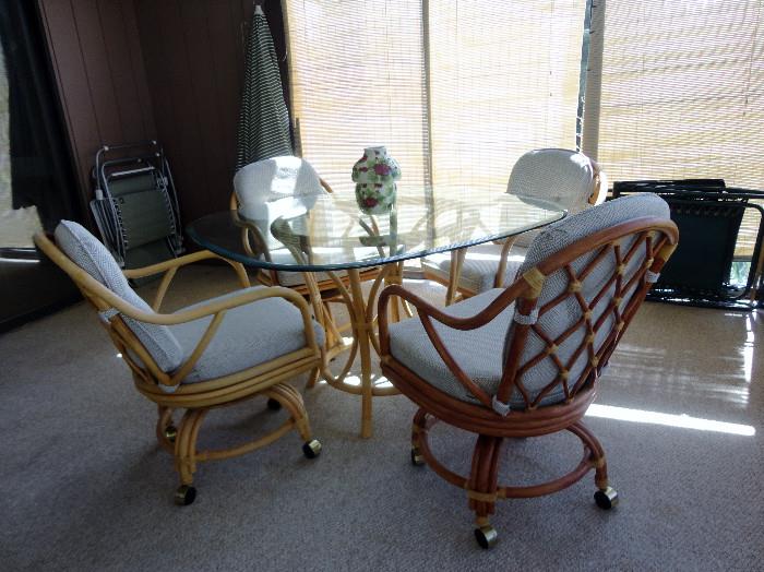Tempered glass table with four matching chairs.