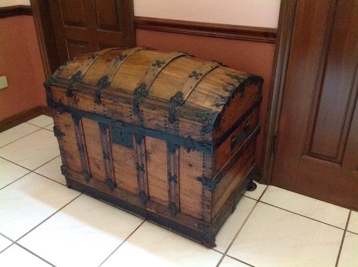 Hump back travel trunk.  This trunk has a small damaged piece on the back.