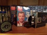 Vintage TV guides from the 90's along with vintage movie camera