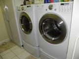 LS front loading washer and dryer with elevating pedestals