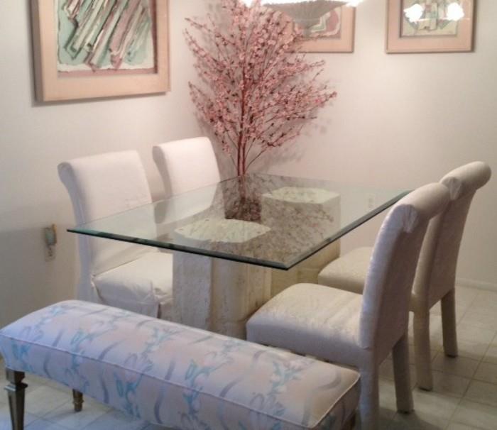 Floral bench w/ gold legs in front of a plaster-base beveled glass dining room table. DR table includes 4 Parsons chairs. The chairs have 4 slipcovers, but we removed 2 of them so you can view the chairs. 