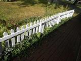four sections of picket fencing , low height fencing