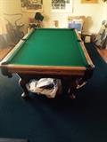 Beautiful pool table in mint condition, with balls, and cues.   Just what every man needs for his man cave 