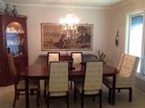 dining table has six upholstered chairs, corner cabinet is custom made with wood from the family farm, beautiful oriental silkscreen