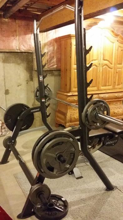 Hoist Squat Rack with Fold Up Bench, selling with weights and bars shown. Like New Condition