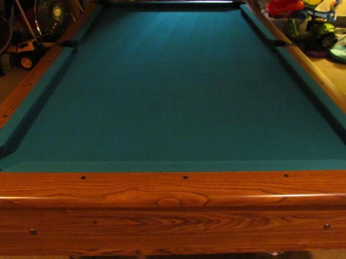 Solid oak regulation size slate pool table. We have a mover that can move this and set it up in your home in less than 1 day for less than $500.00