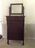 Mahogany chest of drawers with beveled mirror.