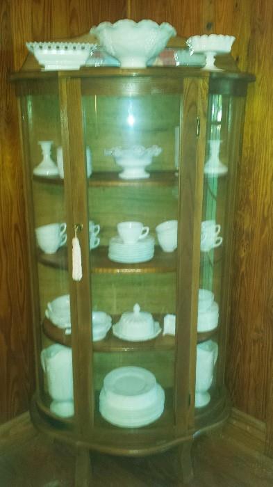 Rounded front curio with part of the extensive milk glass collection including Imperial, Westmoreland, Anchor Hocking, & more!