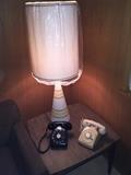Vintage rotary phones, ceramic table lamp and laminate side table