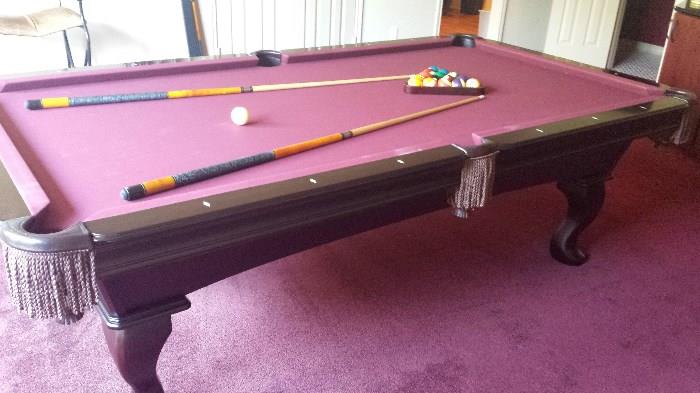 Olhausen 8 ft. pool table.  Cherry with burgundy wool deck.  Balls, ques and racks included. Very little use. $1000.00
