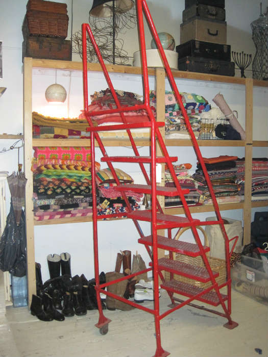 Great industrial rolling ladder. Sorry, top shelf wall items display only - not for sale.