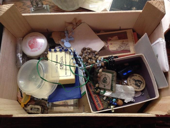 box full of Catholic religious trinkets and medallions