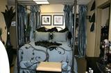 Beautiful black iron canopy bed with matching bedding.